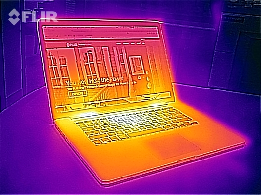 Thermal image of hot parts of a laptop on a table in the living room.